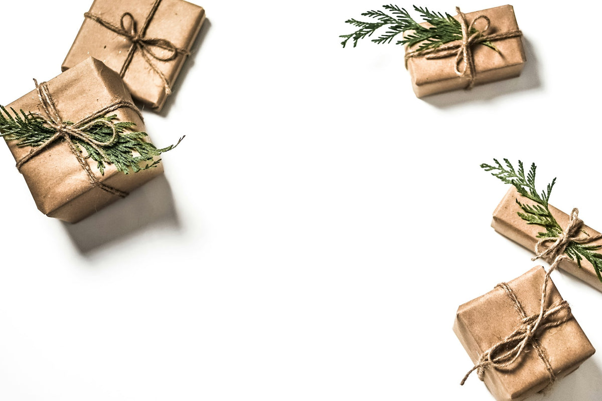 Kraft paper wrapped gift boxes on a white surface, gifts under $25