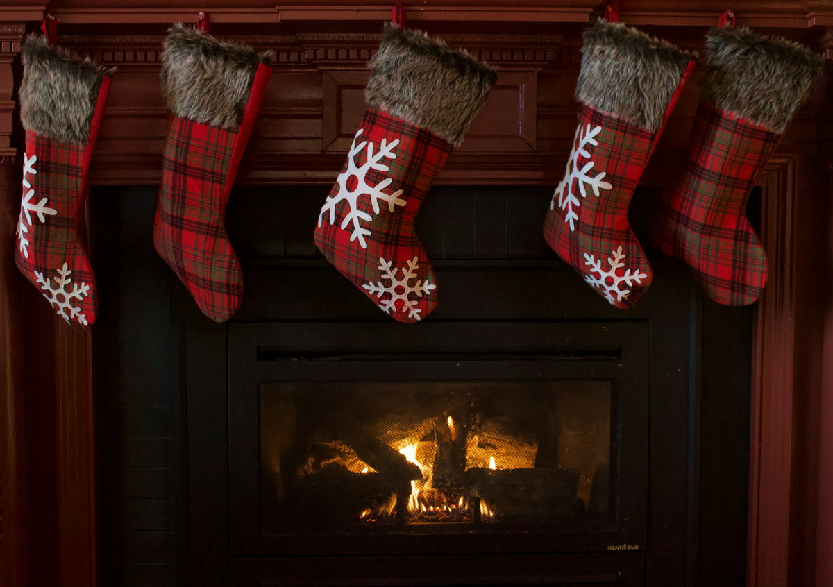 Red and white Christmas stocking hanging on a fireplace, stocking stuffers for adults